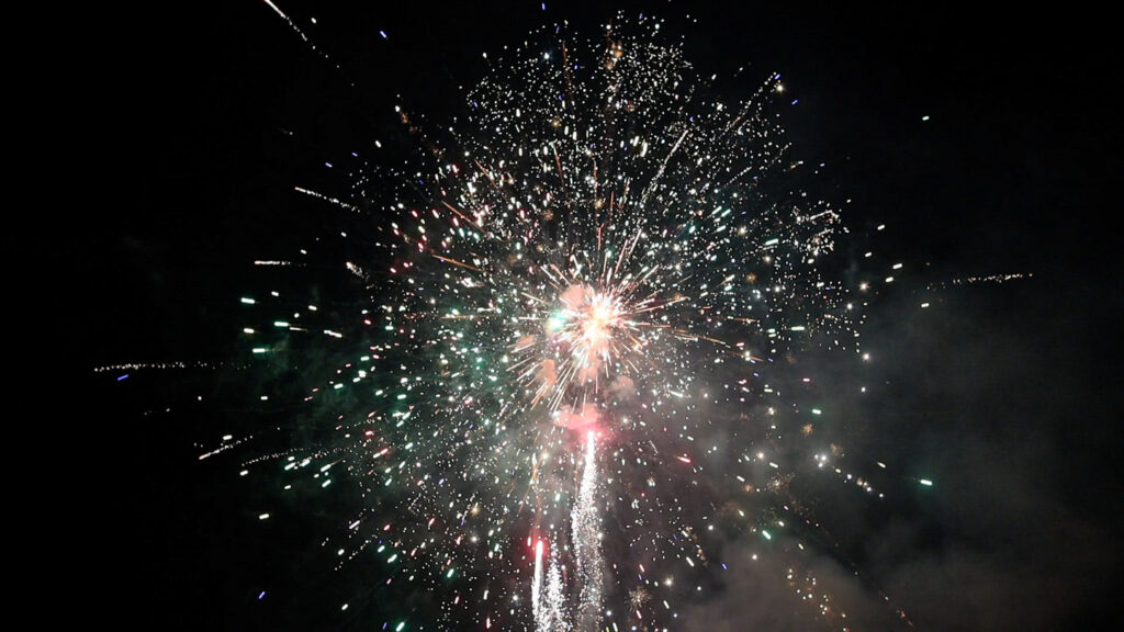 Picture of A firework Exploding at night with a beautiful burst of color and sparkle